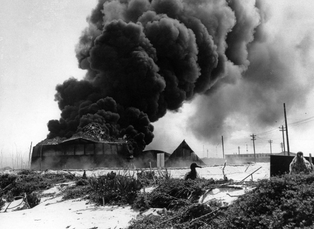 American defenses burn on the Island of Midway after the Japanese attack.