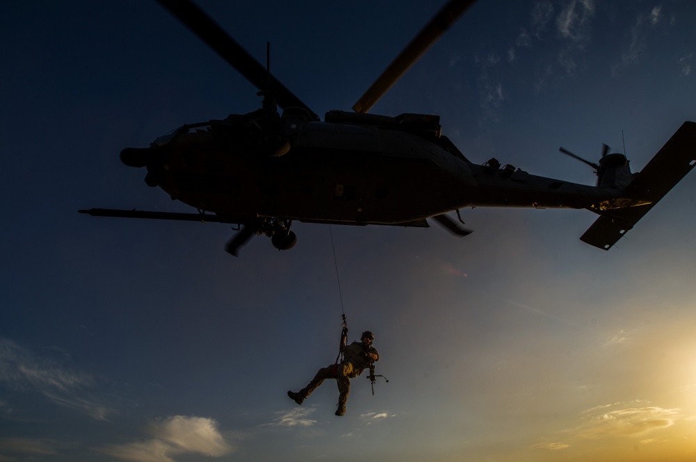 U.S. Air Force pararescueman lowered from a HH-60 Pave Hawk.