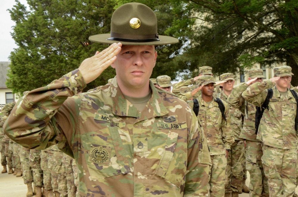 Army Staff Sgt. Joseph D. Moore, an advanced individual training drill sergeant at the U.S. Army Signal School Detachment Student Company on Fort Meade, Md., executes a salute with a formation of soldiers at retreat on May 29, 2018, on Fort Meade. Moore is the first drill sergeant assigned in more than a decade to the detachment, which supports the Defense Information School on Fort Meade. (U.S. Army Photo by Pfc. Lynnwood Thomas)
