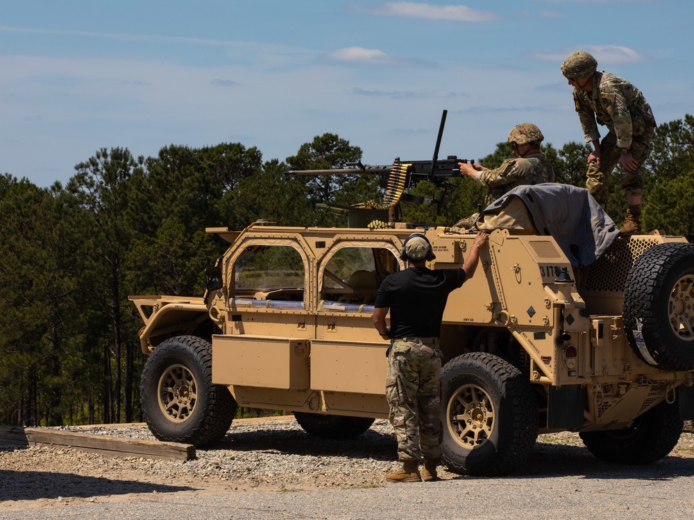 soldier firing machine gun from Humvee