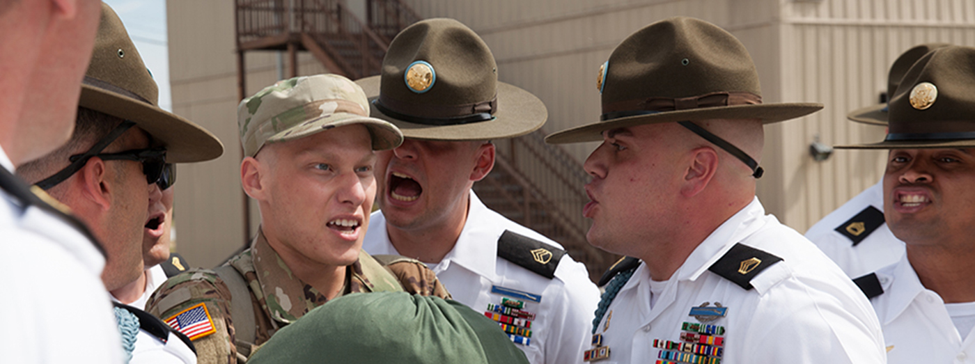 boot camp drill sergeants shouting at soldier