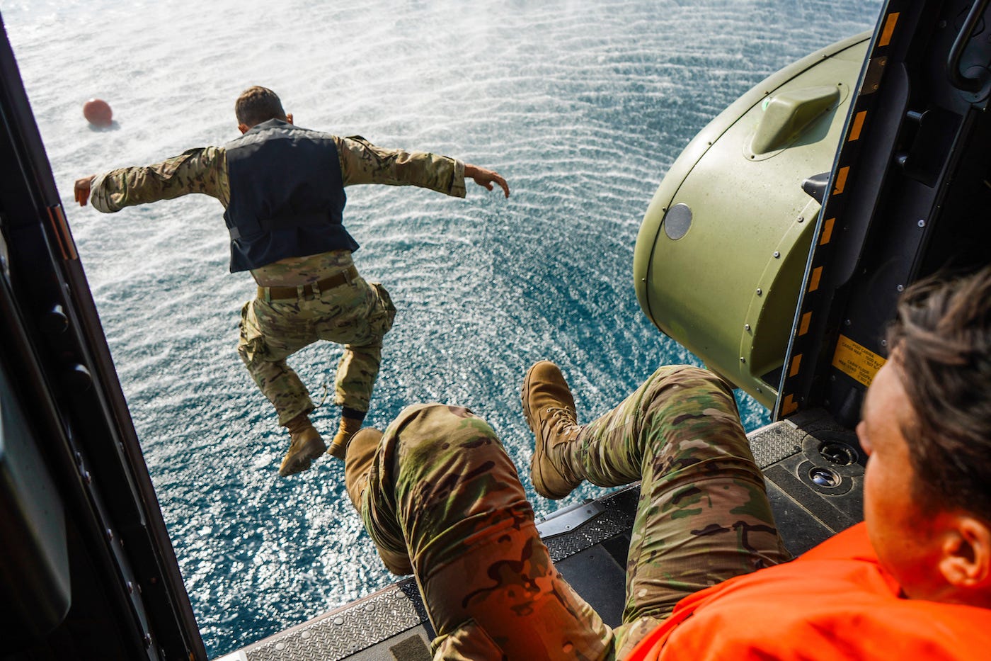soldiers jumping in water