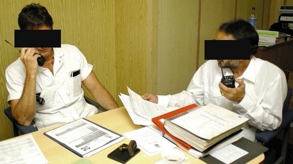 men talking in walkie talkies blacked out faces