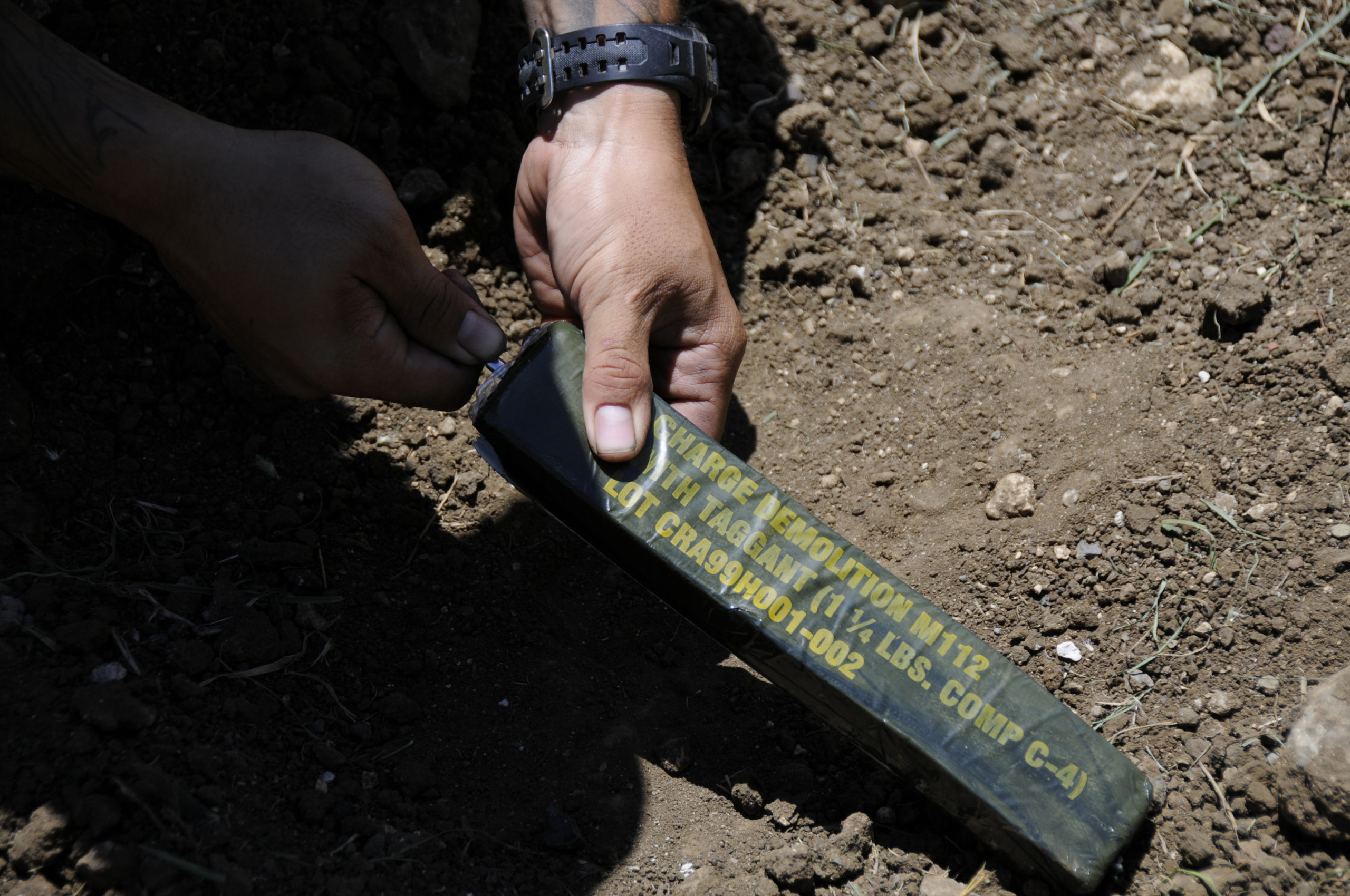 A Marine from 4th Force Reconnaissance Company inserts a blasting cap into a block of C4 explosive during demolition training at the Kaneohe Bay Range Training Facility Aug. 20, 2014 (Wikimedia Commons). Source: https://commons.wikimedia.org/wiki/File:Annual_training_140820-N-AX577-063.jpg 