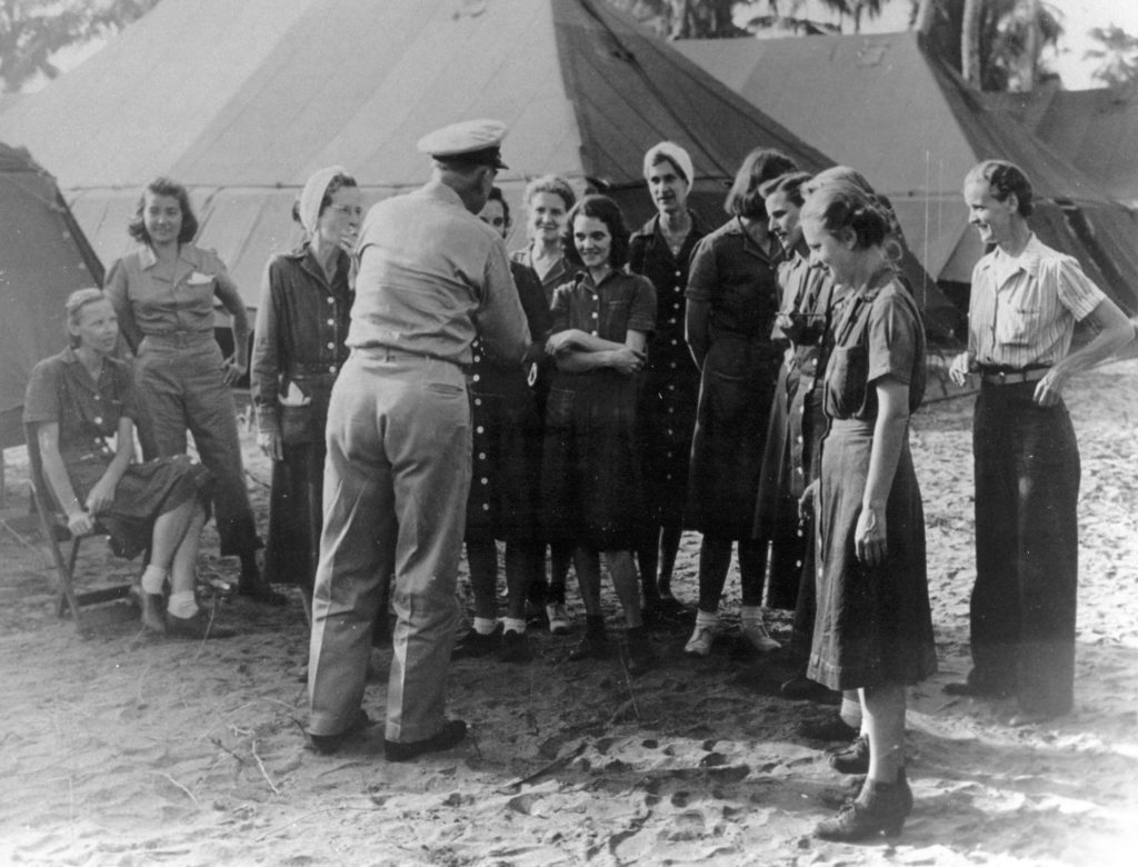 US Navy Nurses rescued from Los Banos. General Kinkaid facing away from camera; Chief Nurse Laura Cobb to immediate left of Gen. Kinkaid with cigarette; Nurse Dorothy Still Danner seated at far left (Wikimedia Commons). Source: https://commons.wikimedia.org/wiki/File:Navy_Nurses_Rescued_from_Los_Banos_2.jpg