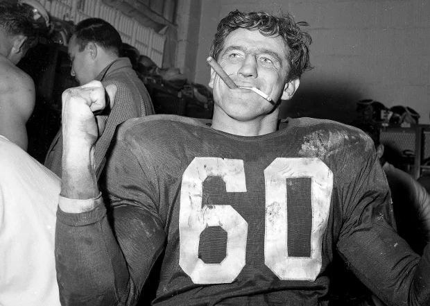 Chuck Bednarik after a win against Green Bay (SI). Source: https://www.si.com/nfl/2015/03/21/si-vault-chuck-bednarik-concrete-charlie-philadelphia-eagles-john-schulian#gid=ci0255855030062511&pid=chuck-bednarik-and-frank-gifford