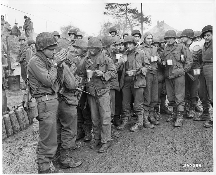 Soldiers of a tank destroyer battalion warm themselves with coffee before going into action against the Germans near Stolberg, Germany