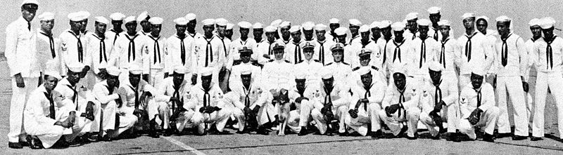 The photo shows the officers, crew, and mascot of the USS PC-1264