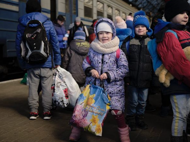 Aerial Recovery rescues 58 orphans. A child is seen smiling with a group of children at a train station (Aerial Recovery Group Instagram). Source: https://www.instagram.com/aerialrecoverygroup/