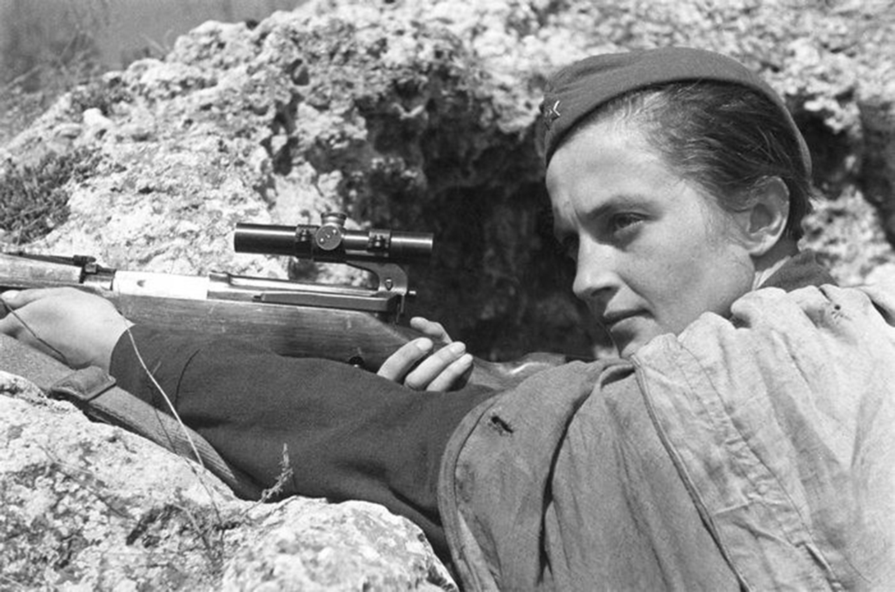 Soviet Sniper Lyudmila Pavlichenko who is credited with 309 confirmed kills (Израиль Абрамович Озерский (1904 - 1971) (author not found out until 21st century), Public domain, via Wikimedia Commons). Source: https://commons.wikimedia.org/wiki/File:Pavlichenko_in_a_trench.jpg