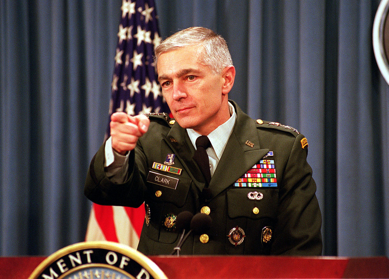 Retired four star General Wesley Clark during a press conference in the Pentagon (Wikimedia Commons, DoD photo by R.D. Ward). Source: https://commons.wikimedia.org/wiki/File:Wesley_Clark_Feb_8,_2000.jpg#filelinks