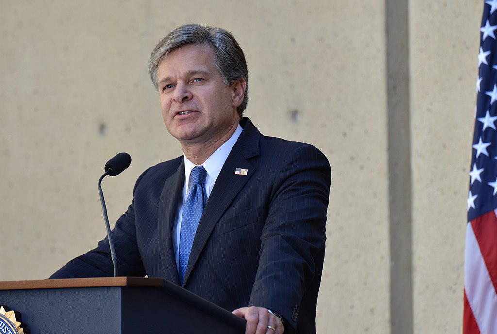Director Christopher Wray addresses the audience during his formal installation ceremony at FBI Headquarters on September 28, 2017 (Federal Bureau of Investigation (FBI), Public domain, via Wikimedia Commons). Source: https://commons.wikimedia.org/wiki/File:Director_Wray_Installation_Ceremony_(24123110718).jpg
