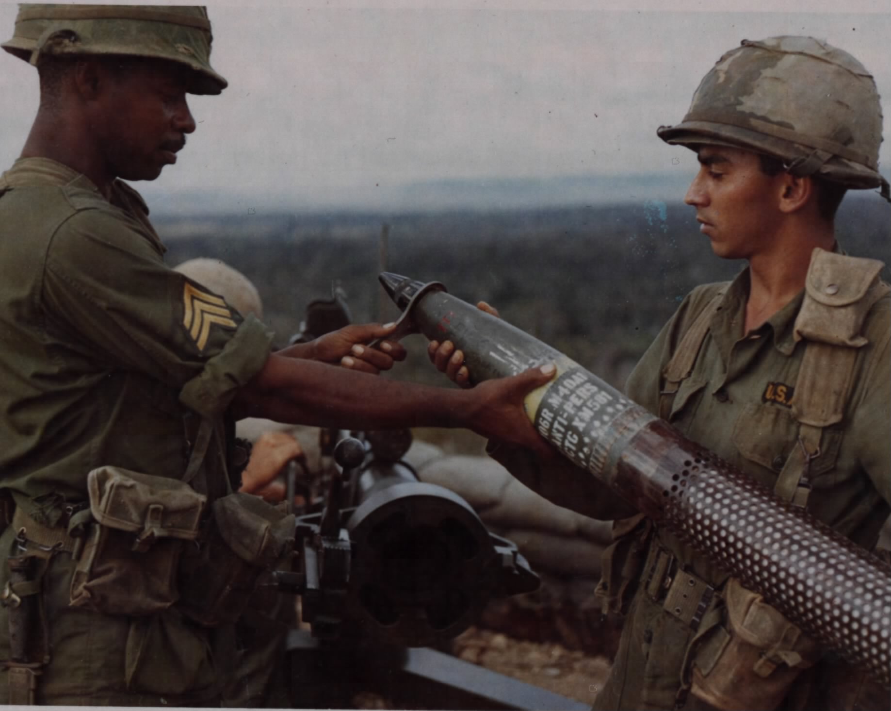 Men of Company "B", 5th Battalion, 7th Cavalry, 1st Cavalry Division (Airmobile) setting the timing on a 106mm (XM 581) Beehive (Anti-personnel) round, An Khe, 31 January 1967 (NARA photo 111-CCV-556-CC38290 by Robert C. Lafoon, Public domain, via Wikimedia Commons). Source: https://commons.wikimedia.org/wiki/File:NARA_photo_111-CCV-556-CC38290.jpg