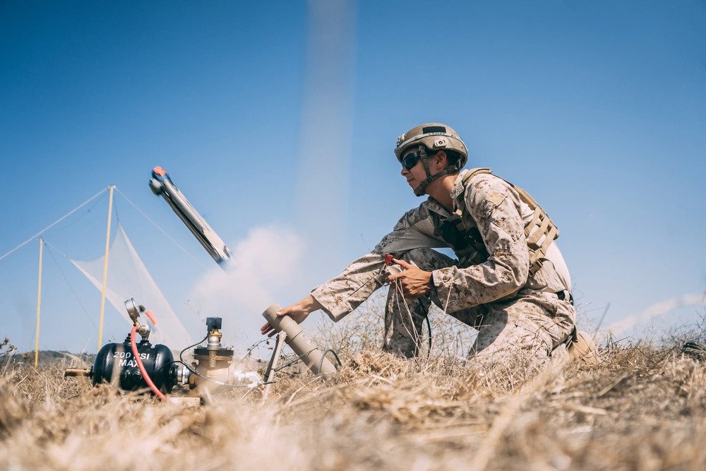 U.S. Marine Corps Cpl. Jonathan Altamirano, a fire support Marine with 1st Air Naval Gunfire Liaison Company (ANGLICO), I Marine Expeditionary Force Information Group, launches a lethal miniature aerial missile system during an exercise at Marine Corps Base Camp Pendleton, California, Sept. 2, 2020. During the exercise, 1st ANGLICO’s mission was to launch, locate, track, lock and engage a simulated enemy target with an unmanned aerial system. (U.S. Marine Corps Photo by Cpl. Jennessa Davey). Source: https://www.dvidshub.net/image/6368008/1st-anglico-trains-with-uas 