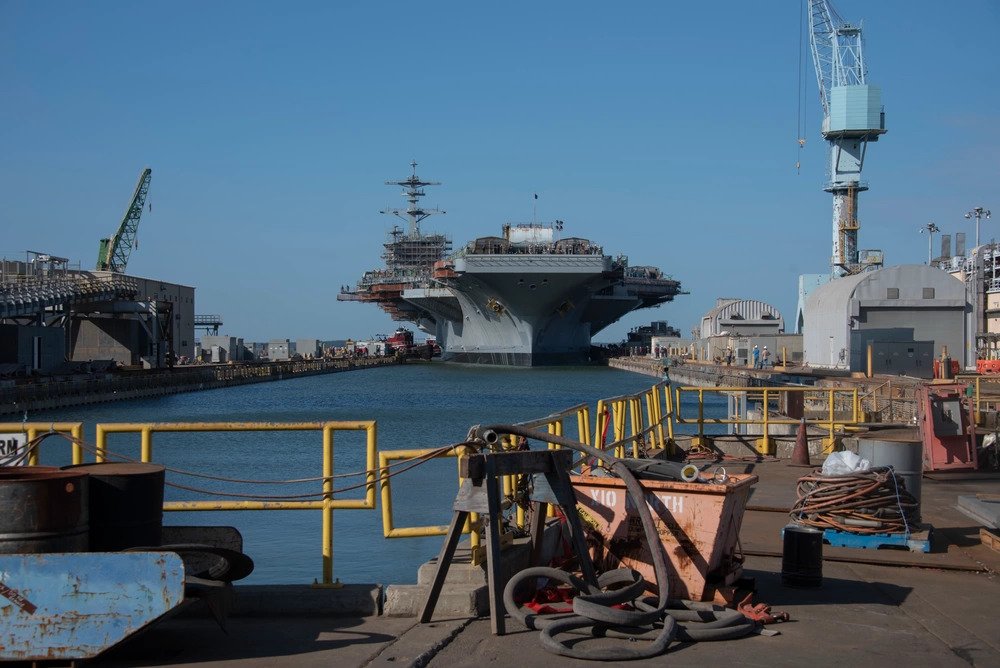 NEWPORT NEWS, Va. (Sept. 27, 2019) The Nimitz-class aircraft carrier USS George Washington (CVN 73) departs the dry dock to moor to a nearby waterside pier at Newport News Shipbuilding (NNS) in Newport News, Va. George Washington is undergoing refueling complex overhaul (RCOH) at NNS ((U.S. Navy photo by Mass Communication Specialist Seaman Cory Daut). Source: https://www.dvidshub.net/image/5791056/uss-george-washington-departs