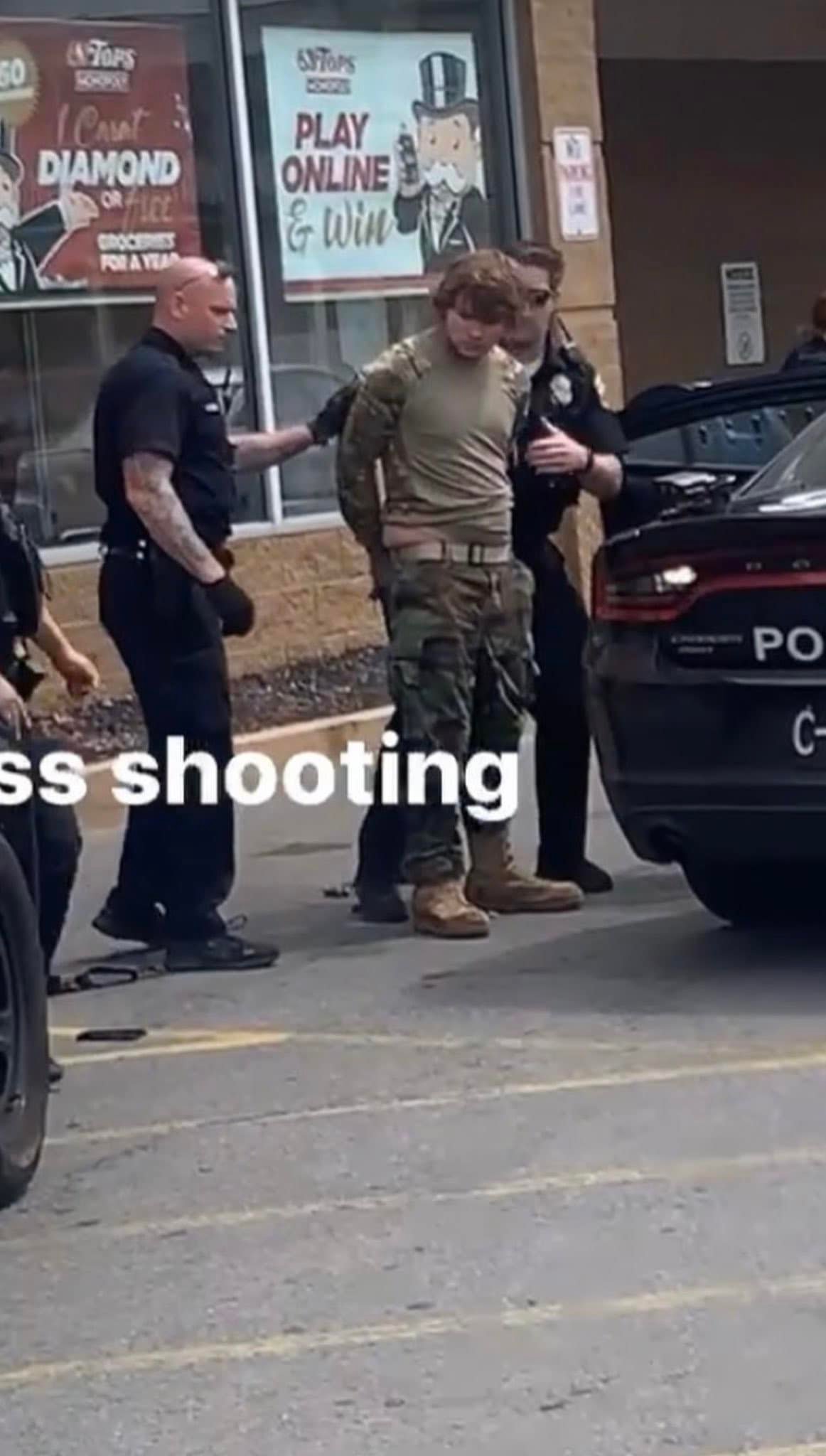 Peter Gendron being arrested after killing 10 people in a Tops store in Buffalo, NY (Alexis Means 13abc). Source: https://www.facebook.com/AlexisMeans13abc/posts/536315754727175