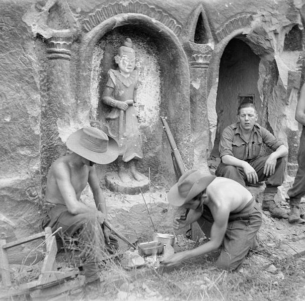 Men of the 26th Indian Infantry Division preparing a meal beside a temple on Ramree Island, January 1945