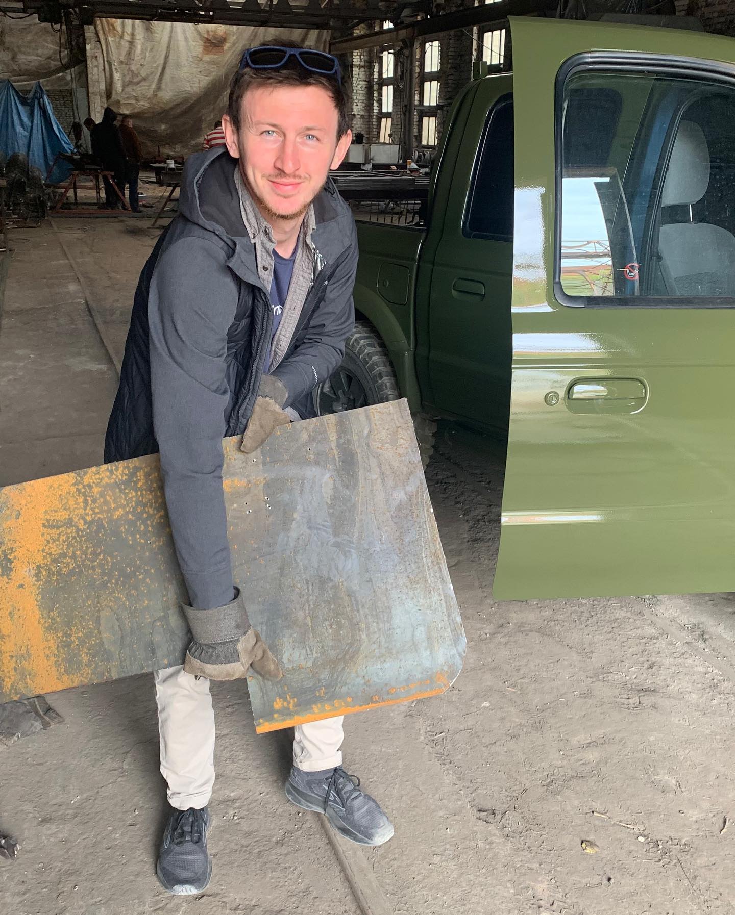 Ivan Oleksii with a metal plate that is to be attached to the truck for more protection and survivability (Car4Ukraine). Source: https://www.facebook.com/car4ukraine/photos/130369046314355