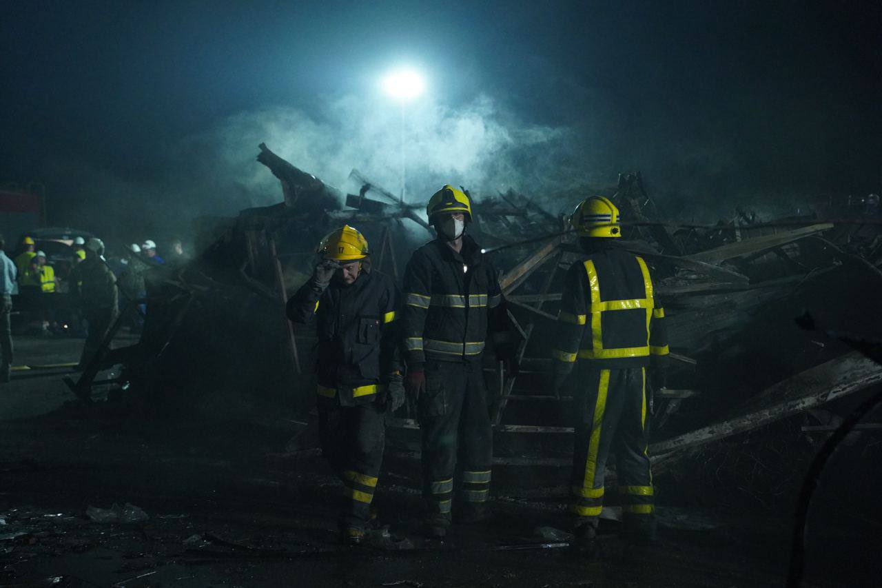 Emergency service personnel on the scene after the Kremenchuk shopping mall missile strike (Lesia Vasylenko).