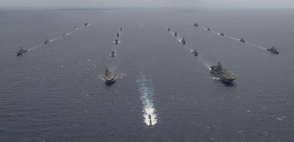 Multinational navy ships and a submarine steam in formation during a group sail off the coast of Hawaii during Exercise Rim of the Pacific (RIMPAC) 2020, August 21. “Like-minded nations come together in RIMPAC in support of a free and open Indo-Pacific where all nations enjoy unfettered access to the seas and airways in accordance with international law and the United Nations Convention on the Law of the Sea (UNCLOS) upon which all nations’ economies depend,” said Adm. John C. Aquilino, Commander U.S. Pacific Fleet. Ten nations, 22 ships, 1 submarine, and more than 5,300 personnel are participating in Exercise Rim of the Pacific (RIMPAC) from August 17 to 31 at sea in the waters surrounding Hawaii. RIMPAC is a biennial exercise designed to foster and sustain cooperative relationships, critical to ensuring the safety of sea lanes and security in support of a free and open Indo-Pacific region. The exercise is a unique training platform designed to enhance interoperability and strategic maritime partnerships. RIMPAC 2020 is the 27th exercise in the series that began in 1971. (Royal Canadian Navy photo by MS Dan Bard). Source: https://www.dvidshub.net/image/6324625/rimpac-2020