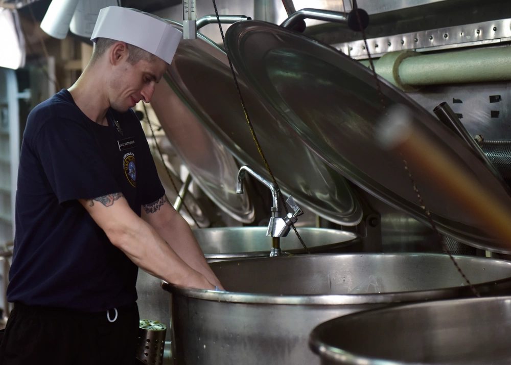 U.S. Navy Culinary Specialist 1st Class Matthew Lako, from Cleavland, Ohio, prepares chicken for dinner aboard the aircraft carrier USS Nimitz (CVN 68), Aug. 7, 2017, in the Arabian Gulf. Nimitz is deployed in the U.S. 5th Fleet area of operations in support of Operation Inherent Resolve. (Source: DIVIDS)