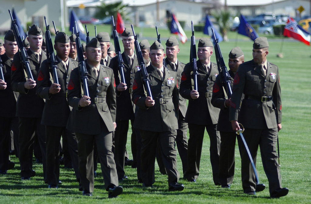 US Marine Corps (USMC) Marines, Headquarters (HQ) Battalion (BN), march in Pass and Review on the Parade Ground at the Post, Relief, and Retirement Ceremony for USMC Sergeant Major (SGM) Stephen Clarke, (outgoing) Marine Corps Air Ground Combat Center (MCAGCC) Sergeant Major (SGTMAJ), held aboard Marine Air Ground Task Force Training Command (MAGTFTC), Twenty-nine Palms, California (CA).