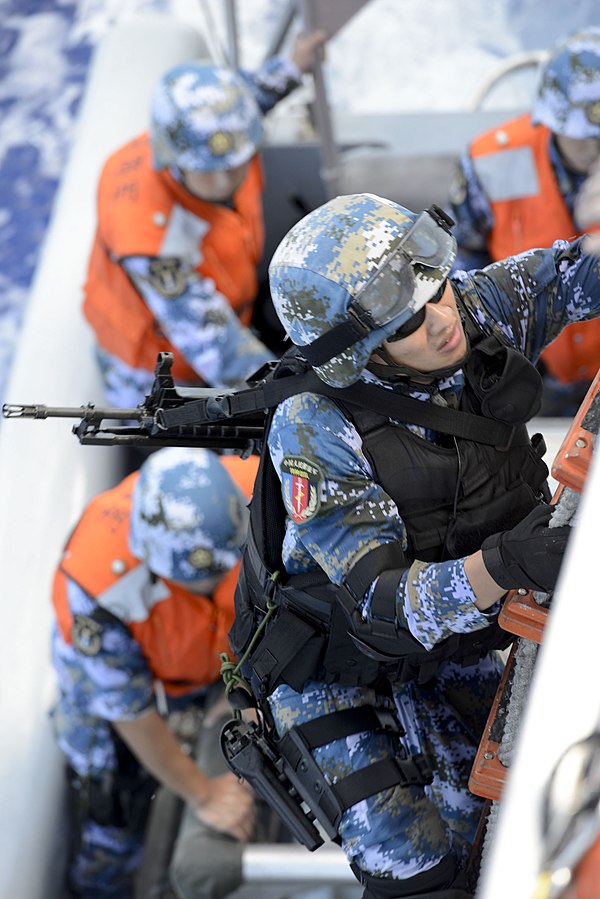 A Chinese sailor with a boarding team assigned to the guided missile destroyer Haikou (DD 171) climbs a ladder to board the national security cutter USCGC Waesche (WMSL 751) in the Pacific Ocean July 16, 2014, during a maritime interdiction operations exercise as part of Rim of the Pacific (RIMPAC) 2014. RIMPAC is a U.S. Pacific Fleet-hosted biennial multinational maritime exercise designed to foster and sustain international cooperation on the security of the world's oceans. (DoD photo by Public Affairs Specialist 3rd Class Manda M. Emery, U.S. Coast Guard/Released)