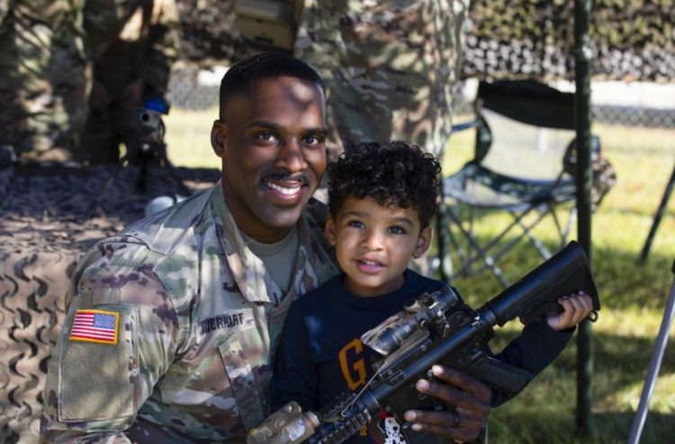 The Pic of the Day: US Army Staff Sgt Poses With Son During Family Day Event at Camp Georgia