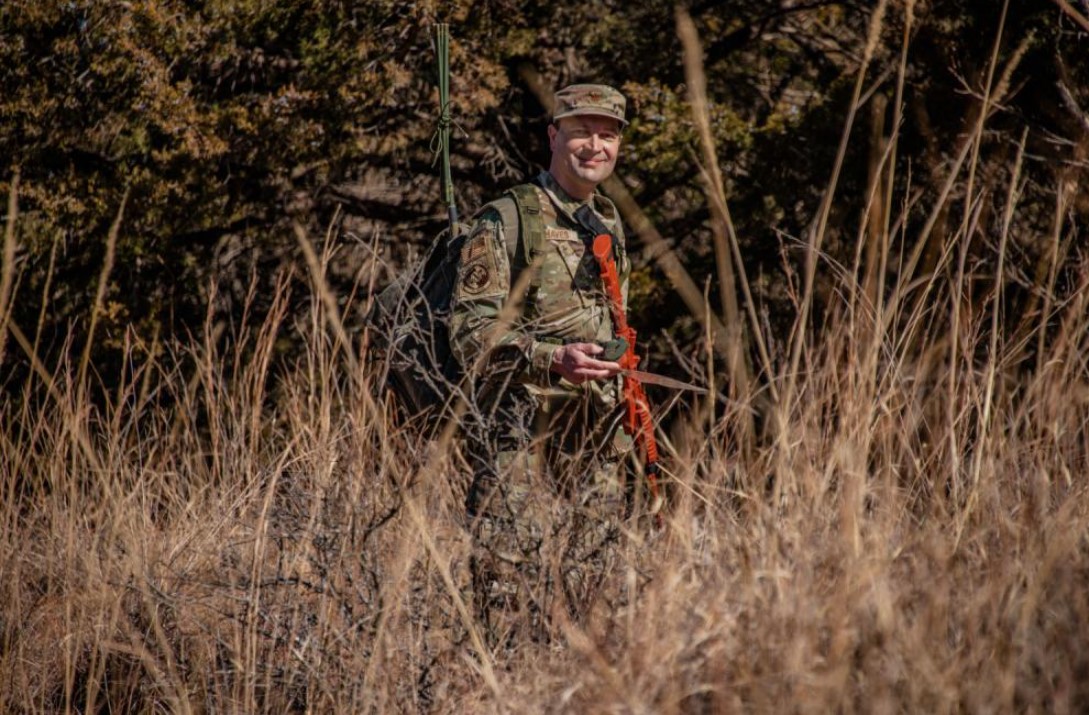 U.S. Air Force Maj. Neil Chaves, current 137th Special Operations Wing mission sustainment team officer in charge, walks through high grass during Mission Sustainment Team field training Feb. 10, 2022, Oklahoma City. Chaves said that being part of the Mission Sustainment Team has created an environment that encourages Airmen to find innovative solutions to issues in an austere environment no matter what rank, similar to what was required of his team during Operation Allies Welcome. (U.S. Air National Guard photo by Tech. Sgt. Brigette Waltermire)