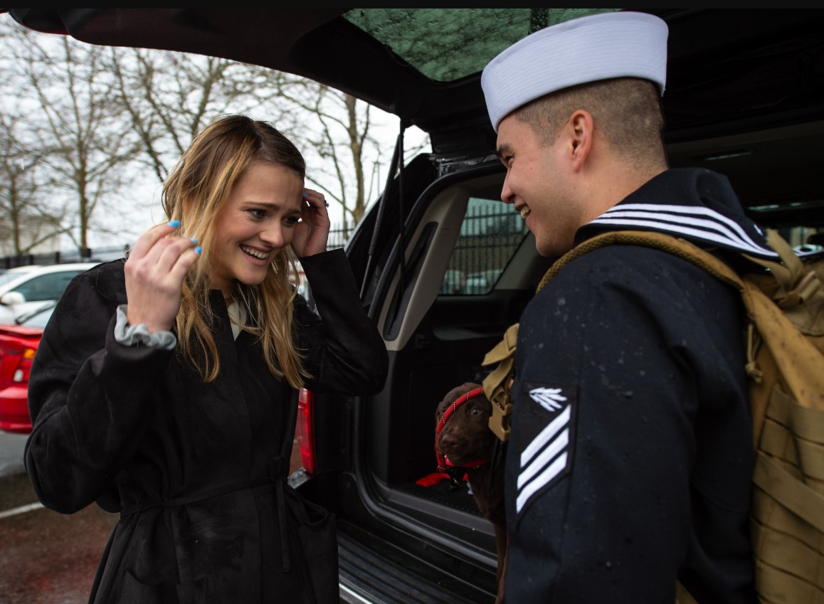nformation Systems Technician 3rd Class Nathan Bumanglag, from Phoenix, Ariz., assigned to the aircraft carrier USS Nimitz (CVN-68), greets his wife and dog following his return from deployment on March 4, 2021. US Navy Photo