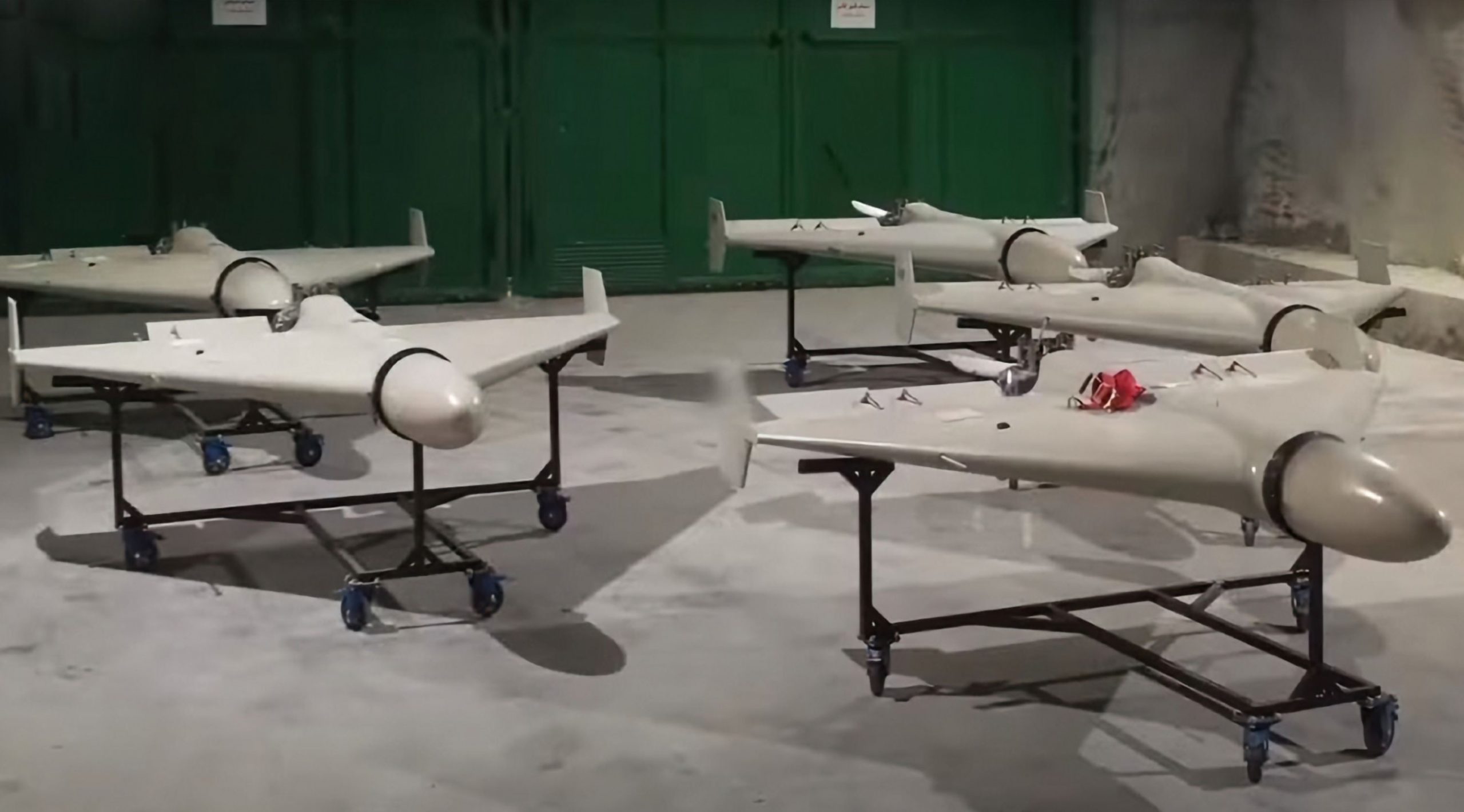 Iranian drones sit on stands in a room