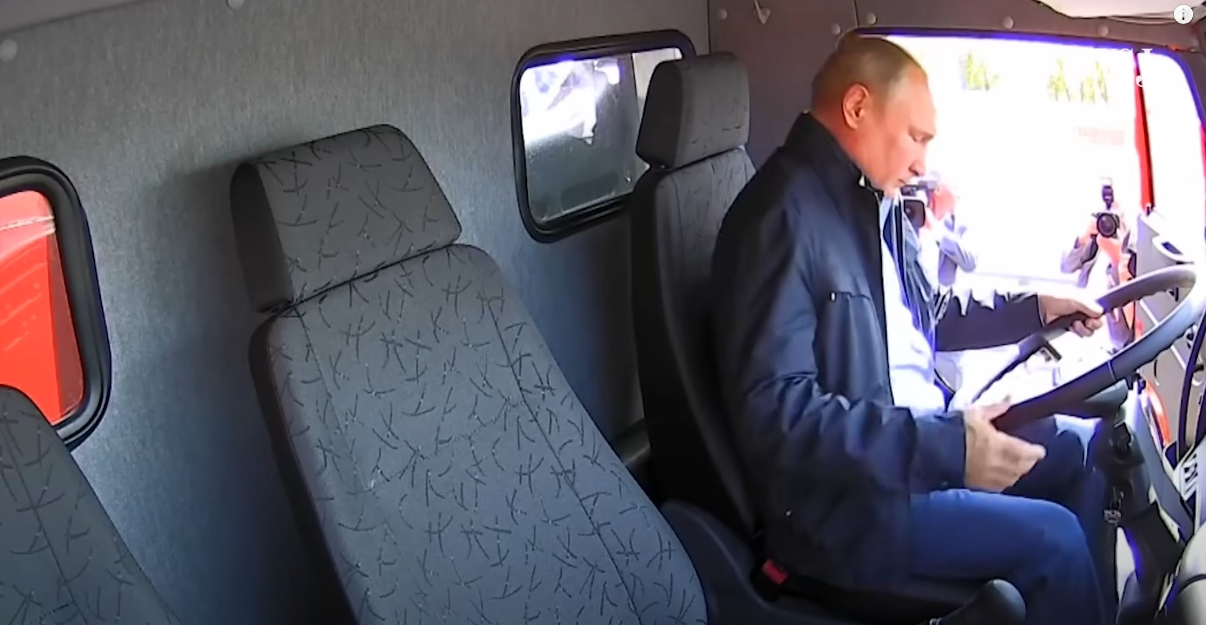 Putin in the cab of a truck preparing to drive over the Crimean Bridge