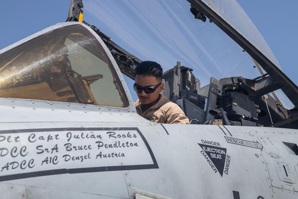 U.S. Marine Corps Lance Cpl. Ruben Estrada, a firefighter technician with Marine Wing Support Squadron (MWSS) 473, 4th Marine Aircraft Wing, inspects an A-10 Warthog at Marine Corps Air-Ground Combat Center, Twentynine Palms, Calif. on July 18, 2022. Marines from Marine Air Control Squadron 24 controlled the U.S. Air Force A-10s as they landed and then received fuel from Marines with MWSS-473. (U.S. Marine Corps Photo by Cpl. Ryan Schmid)
