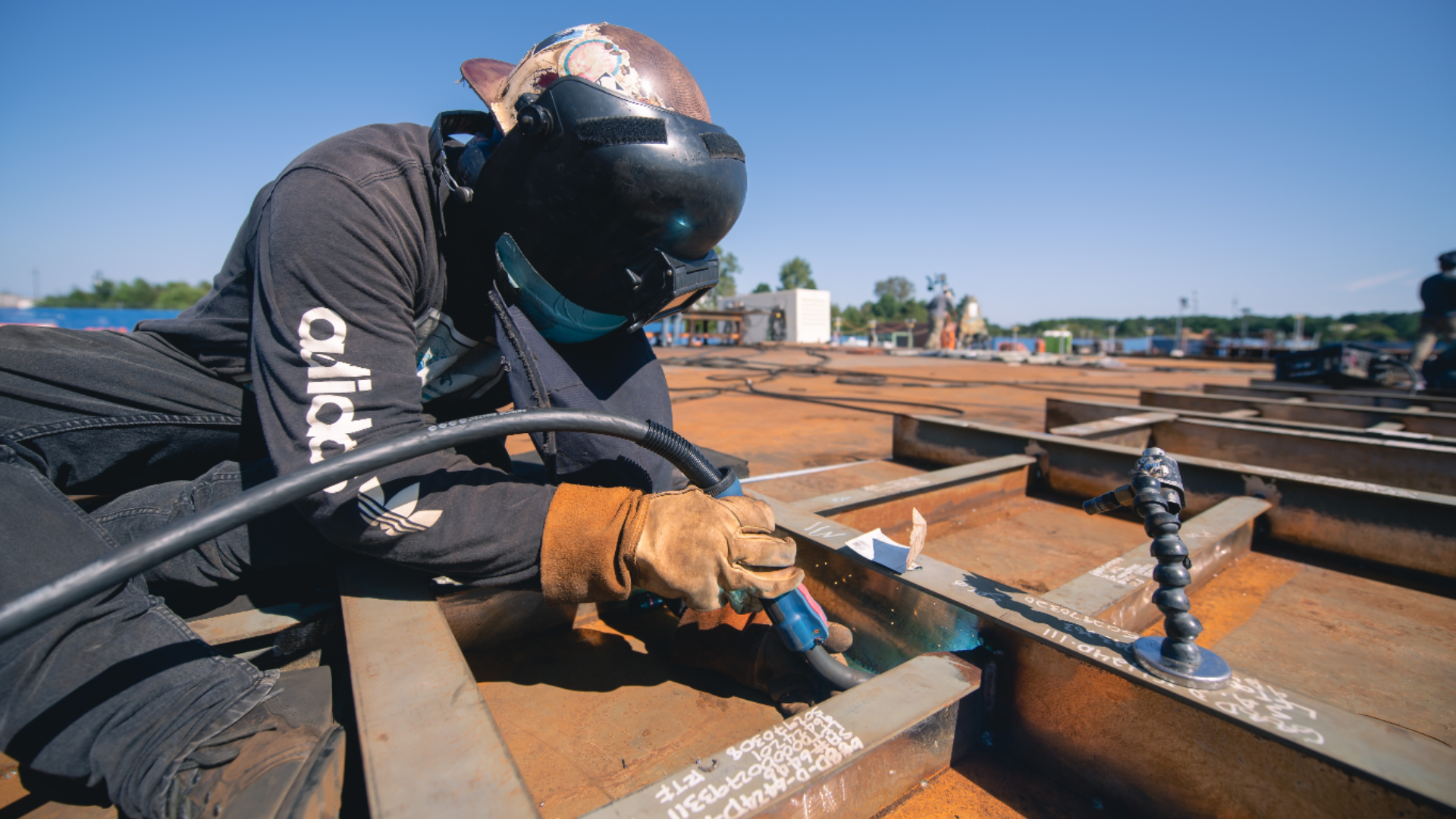 a welder works on a steel panel