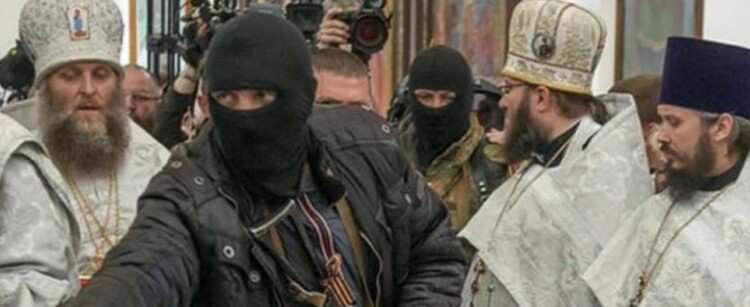 SOFREP Pic of the Day: Pro Russian Rebel Pays Respects to the Dead in Donbas, 2014