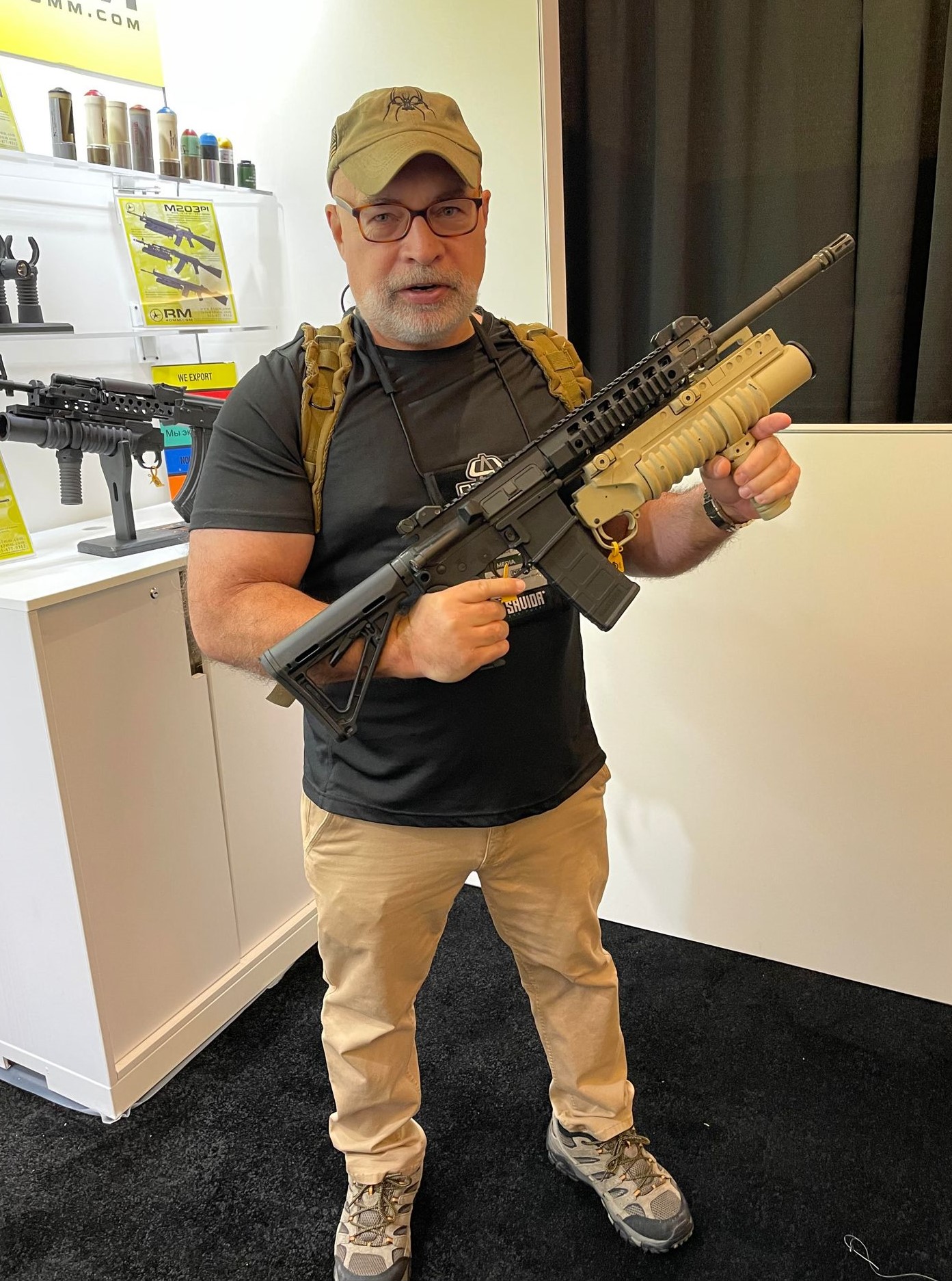 Guy holding an M203 at SHOT Show