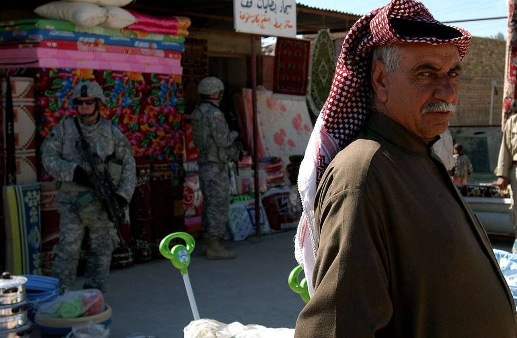 An Iraqi man eyes US soldiers in Taji. 