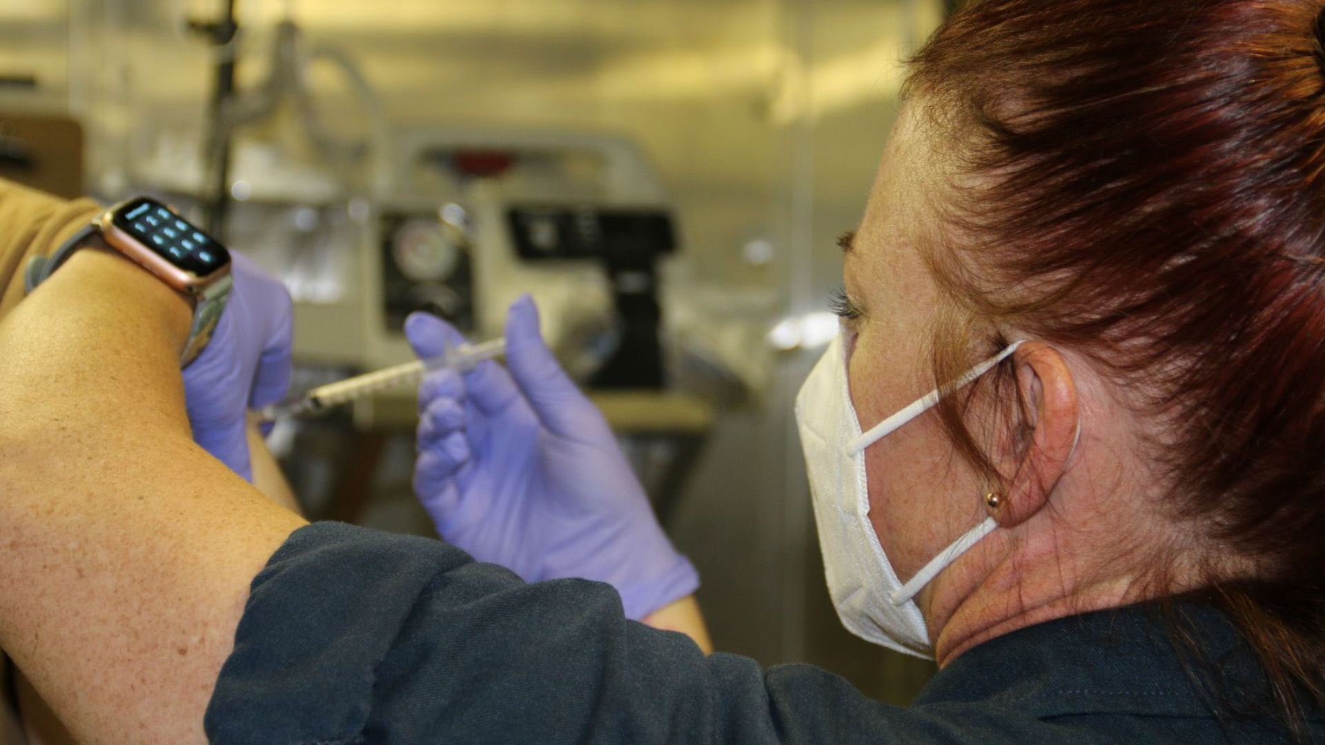 a sailor receive COVID-19 booster shot