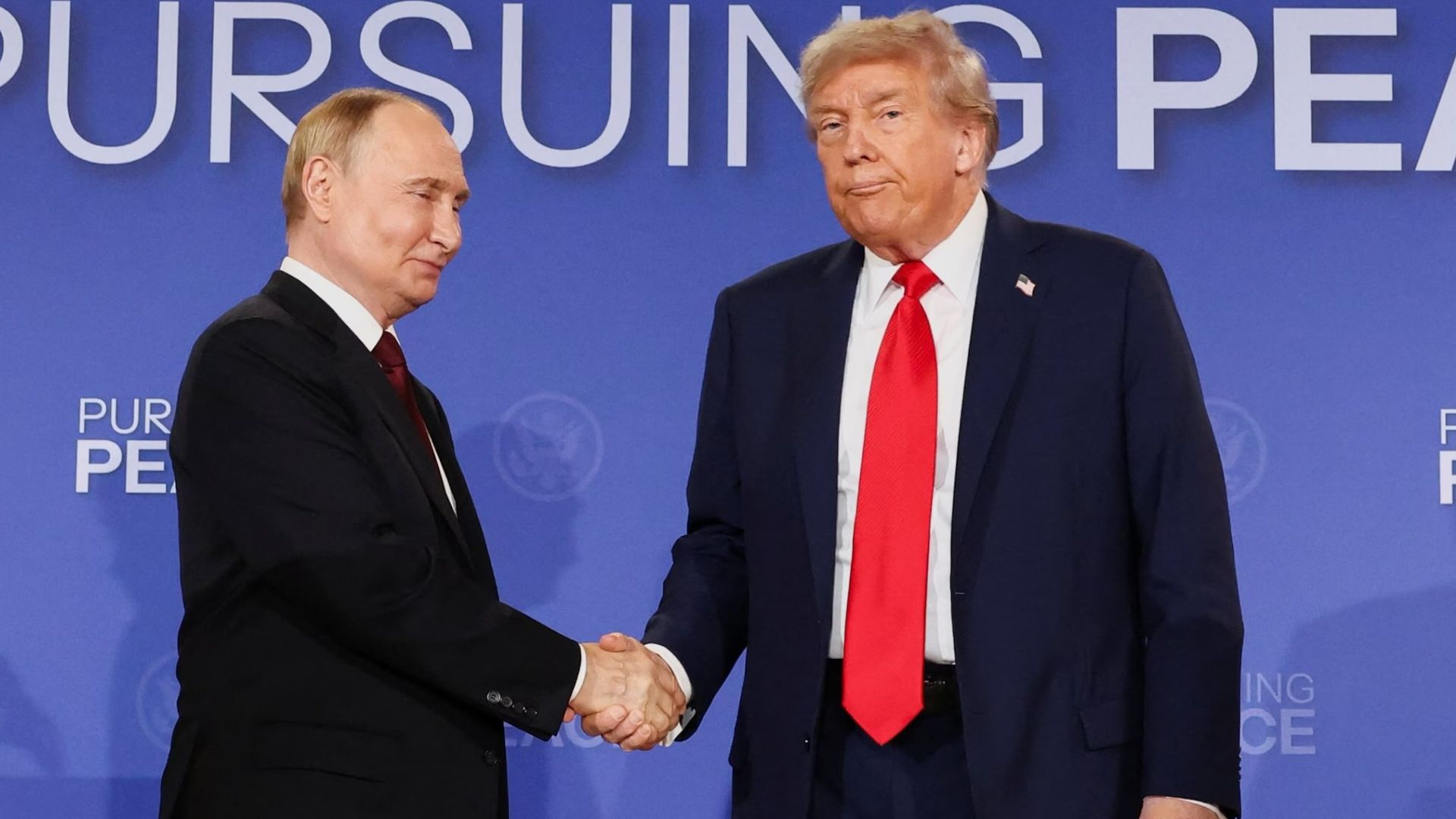 Trump shakes hands with Putin