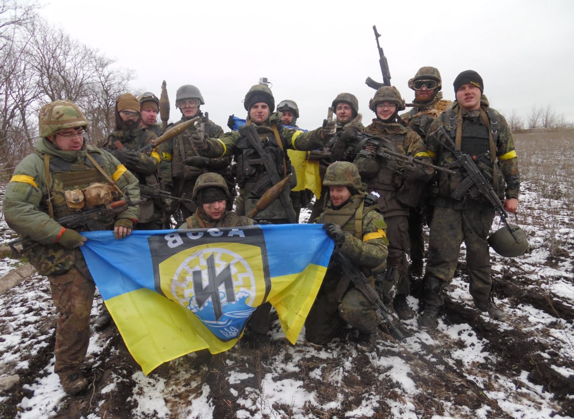 Armed members of the Azov Battalion posing together in Ukraine.