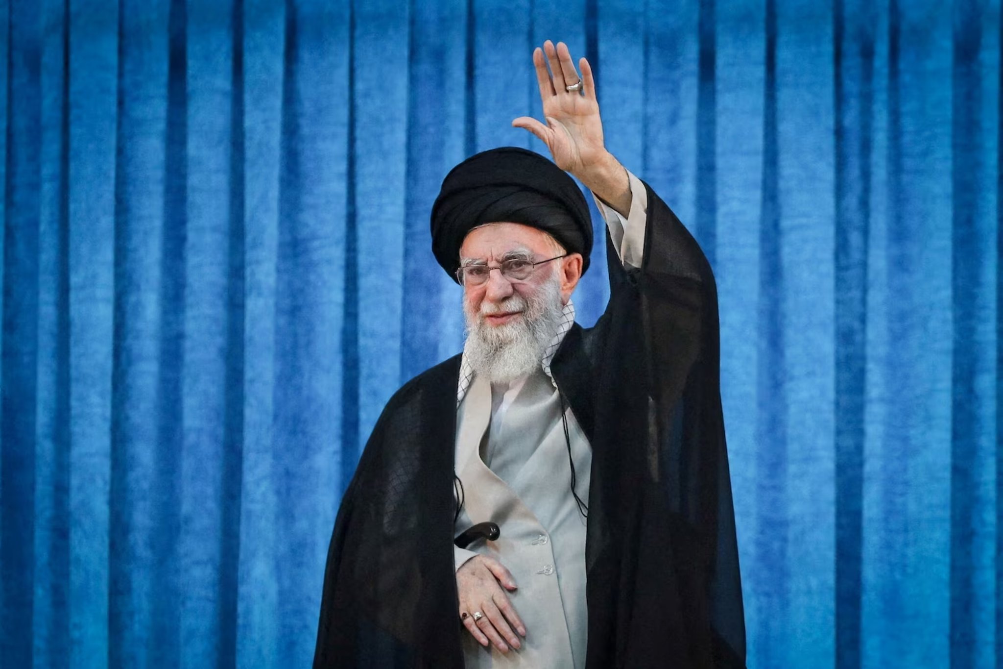 Iran’s Supreme Leader Ayatollah Ali Khamenei raises his hand while addressing a ceremony in Tehran amid tensions in the Strait of Hormuz
