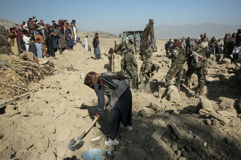Taliban security personnel and civilians dig through rubble and debris at the site of a residential area struck by an overnight Pakistani air attack in Nangarhar province, Afghanistan.